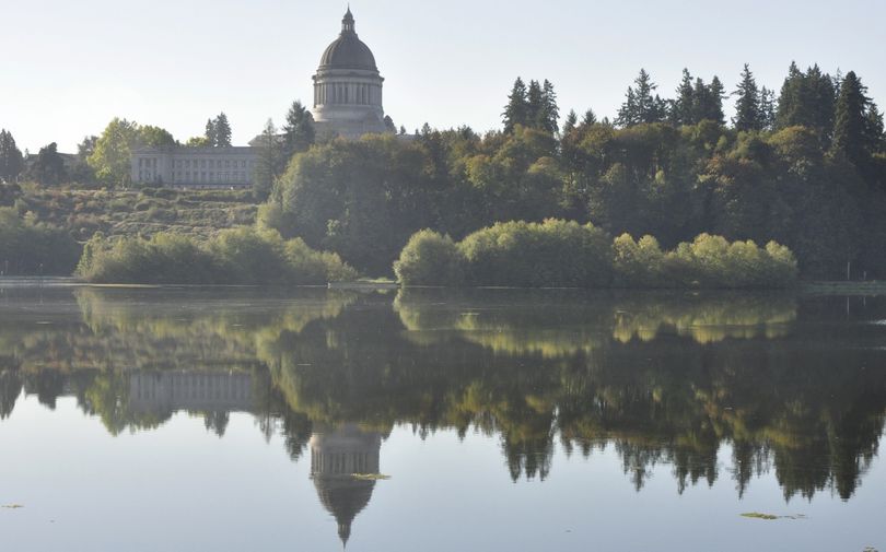 OLYMPIA -- The Washington Legislative Building reflected in a calm Capitol Lake on Sept. 29, 2015. (Jim Camden/Spokesman-Review)