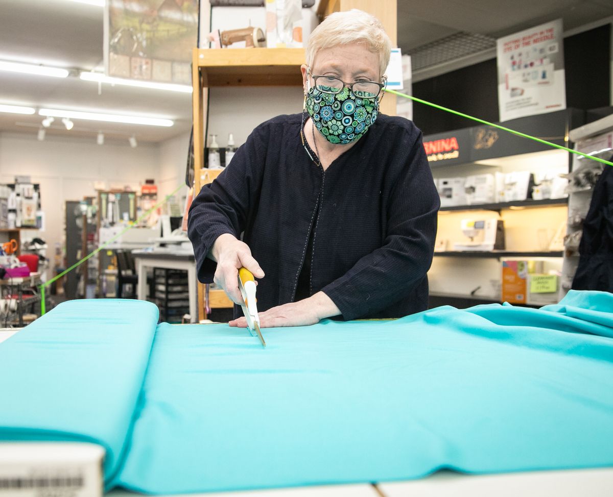 Virginia Powell cuts fabric for a customer at Sew E-Z Too on June 15, 2020 in Spokane