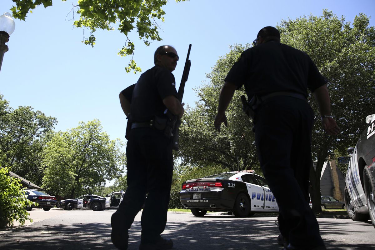 Dallas Police walk a neighborhood a block away from a shooting in Dallas, Monday, May 1, 2017. Authorities said a Dallas paramedic has been shot while responding to a shooting call. (LM Otero / Associated Press)