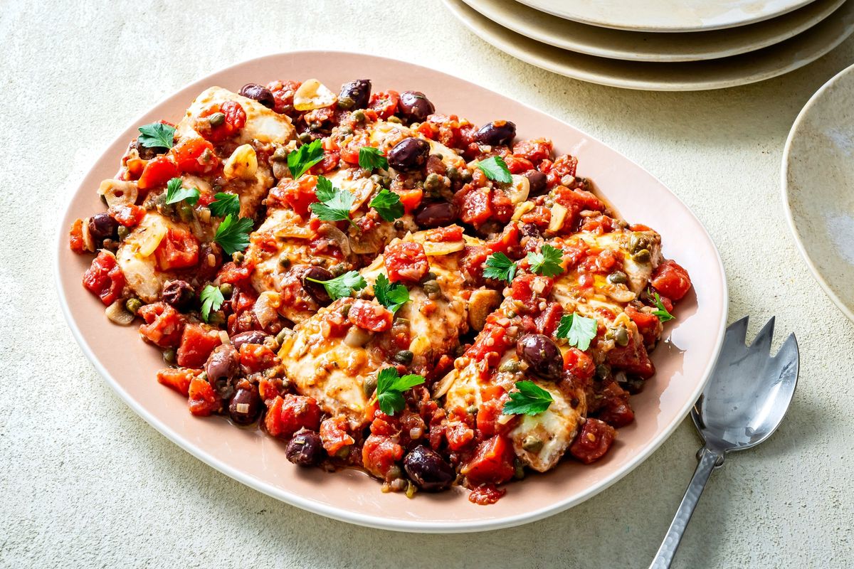 This puttanesca recipe uses halibut, but other flaky white fish, such as snapper and mahi mahi, can be substituted in the versatile dish.  (Scott Suchman/For the Washington Post)