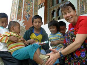 
Jane Schelly, pictured here at a Bhutan monastery, wears modest clothing and connects with locals in her travels.
 (The Spokesman-Review)