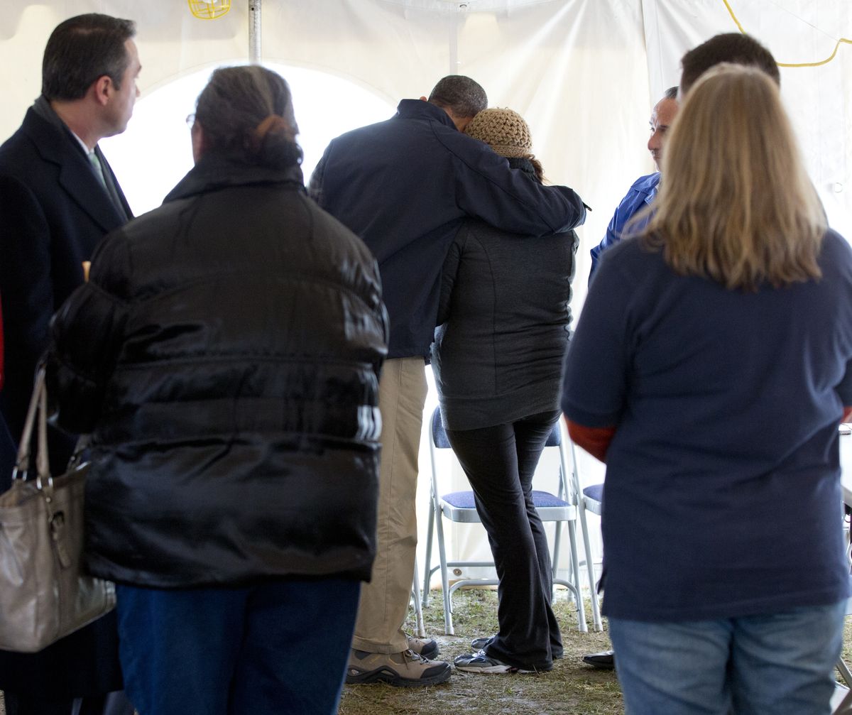 President Barack Obama comforts a woman at the FEMA recovery center on the grounds of New Dorp High School, Thursday, Nov. 15, 2012, on Staten Island, in New York. (Carolyn Kaster / Associated Press)