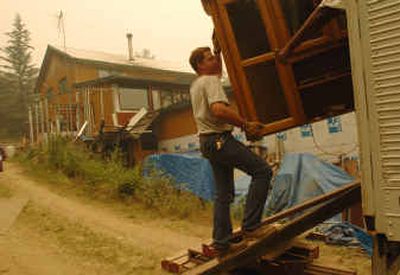 
Darrin Foster loads the contents of his home near Fairbanks, Alaska, into a truck. Hundreds of people and their pets fled a wildfire in Alaska's Interior on Thursday as fire crews knocked on doors to urge others living along the Elliott Highway to pack their things and leave as soon as possible. 
 (Associated Press / The Spokesman-Review)