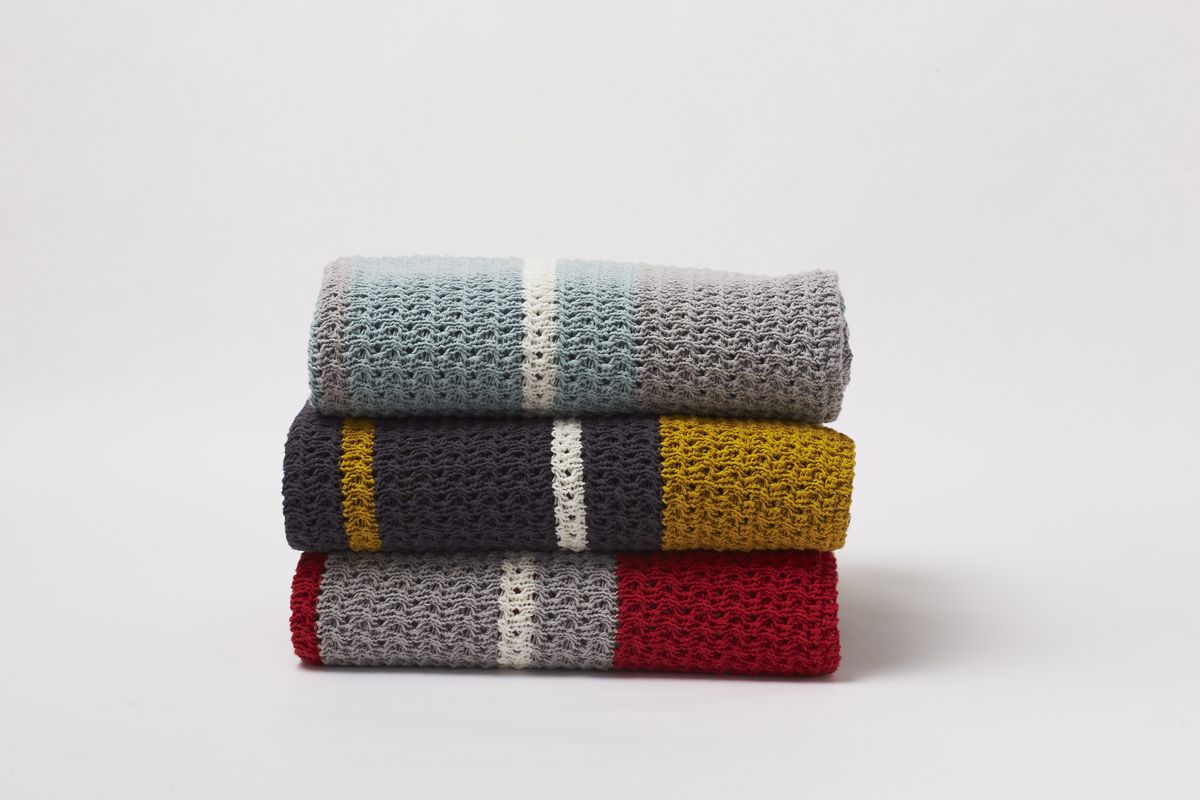 Coyuchi’s chunky, yarn-dyed knit throws bring cozy and contemporary together. (Associated Press)