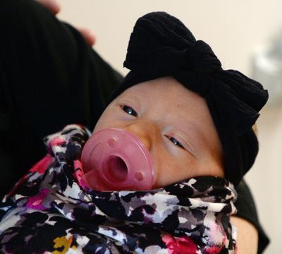Three-day old Bayne Marsh peeks up at her parents, Korey and MaKenzie Marsh, of Herriman Utah, at the Women's and Newborn Center at the Intermountain Medical Center in Murray, Utah, earlier this month. (Steve Griffin / Salt Lake Tribune via AP)
