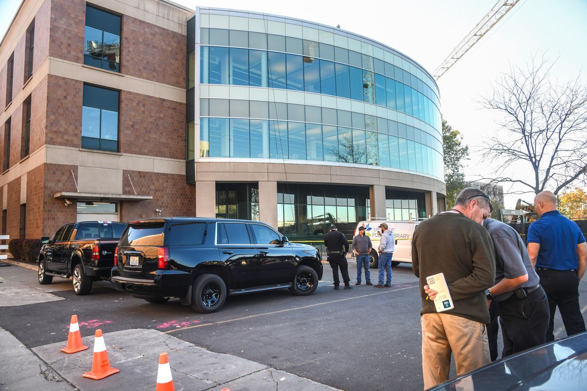 Law enforcement gathers at the Downtown Spokane Public Library after a window washer fell to his death, Wednesday, Oct. 17, 2018. (Dan Pelle / The Spokesman-Review)
