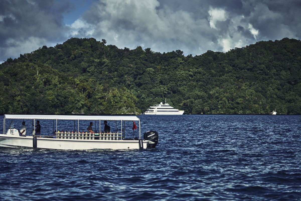 Despite not having diplomatic relations with China, Palau has seen an influx of Chinese tourists and investors. Here, a dive boat and a luxury yacht are seen near Palau