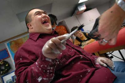 
Barker High School special needs student Billy Berg, 18, laughs while working on a craft project. 
 (Brian Plonka Photos / The Spokesman-Review)