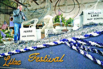 
Arne Weinman takes a phone call while standing on one of the floats in a warehouse in Spokane on Tuesday.  The Lilac Festival has been looking for more community support to keep the annual parade and other events going. 
 (Photos by Holly Pickett / The Spokesman-Review)