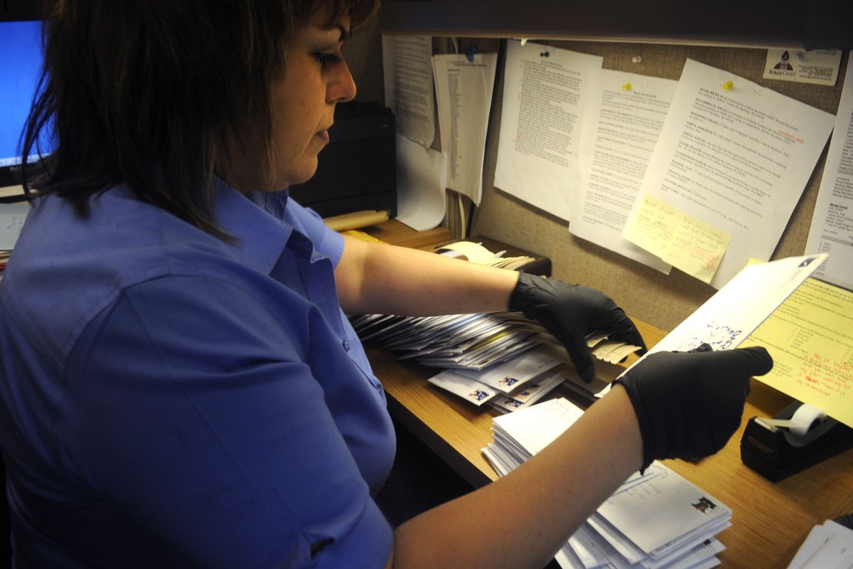 Spokane County sheriff’s clerk Patty Aguilar sorts the day’s mail at the county jail on Friday.  (Jesse Tinsley)