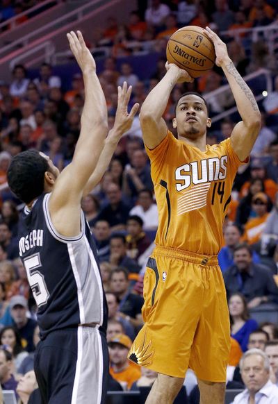 The Suns’ Gerald Green shoots over the Spurs’ Cory Joseph during Phoenix’s victory that ended San Antonio’s four-game win streak. (Associated Press)