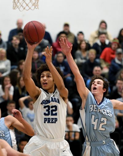 Gonzaga Prep forward Anton Watson (32) lines up a shot as Central Valley guard Grant Hannan (42) defends during GSL game in January. (Colin Mulvany / The Spokesman-Review)