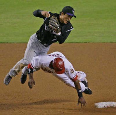 
Diamondbacks' Justin Upton was called for interference as he takes out Rockies second baseman Kazuo Matsui with the call resulting in a double play in the seventh inning. Associated Press
 (Associated Press / The Spokesman-Review)
