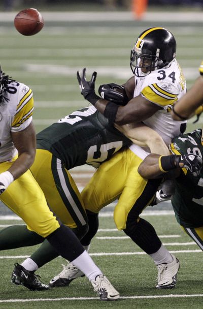 Steelers running back Rashard Mendenhall watches his fumble squirt away as he’s hit by the Packers’ Clay Matthews (52). (Associated Press)