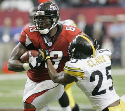 
 Falcons tight end Alge Crumpler tries to elude  Steelers safety Ryan Clark after a reception. 
 (Associated Press / The Spokesman-Review)