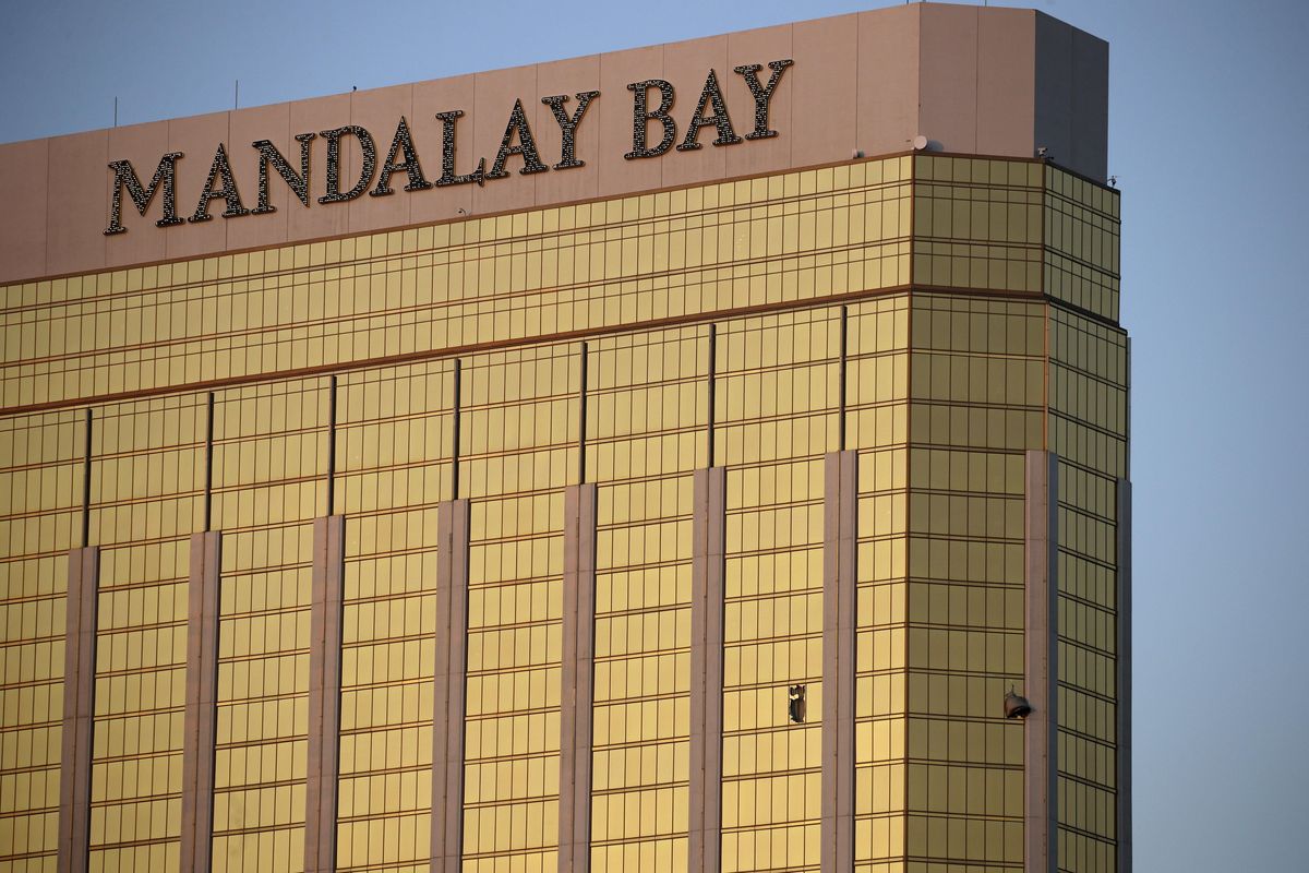 In this Monday, Oct. 2, 2017,  photo, drapes billow out of broken windows at the Mandalay Bay resort and casino on the Las Vegas Strip, following a deadly shooting at a music festival. (John Locher / Associated Press)