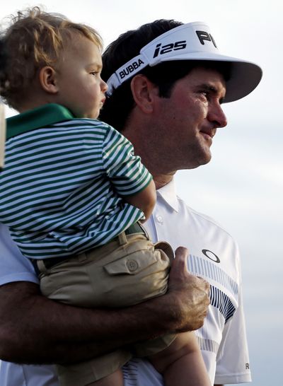 Bubba Watson carries his son Caleb after winning the Masters golf tournament. (AP)