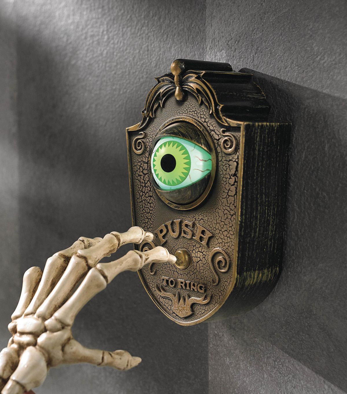 This undated photo provided by Grandin Road shows a vintage style doorbell which keeps an eye out – literally – for Halloween guests. The ghoulish green animated eyeball pops open when the button