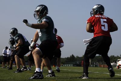 Philadelphia quarterback Donovan McNabb (right) gets in some work with his offensive linemen on Tuesday. (Associated Press / The Spokesman-Review)