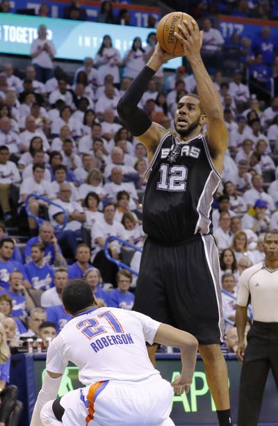 Spurs’ LaMarcus Aldridge shoots over Thunder’s Andre Roberson. (Alonzo Adams / Associated Press)