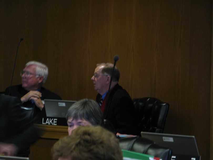Reps. Jim Clark, R-Hayden Lake, left, and Dennis Lake, R-Blackfoot, right, watch as the House votes on HB 4, a one-word change in state law to allow for the fact that housing prices go down, as well as up, 1/26/09 (Betsy Russell / The Spokesman-Review)