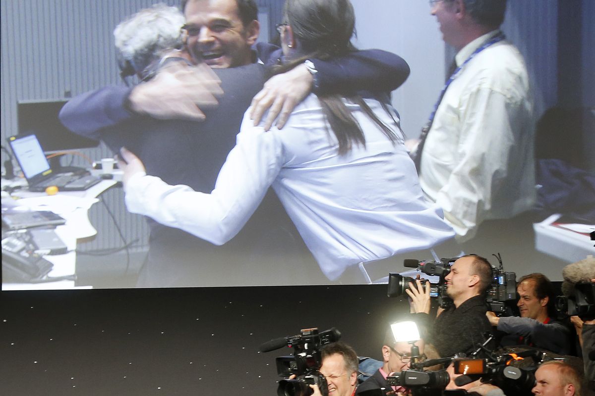 Celebrating scientists in the main control room appear on a video screen at the European Space Agency after the first unmanned spacecraft Philae landed on a comet called 67P/Churyumov-Gerasimenko, in  Darmstadt, Germany, Wednesday, Nov. 12, 2014. Europe