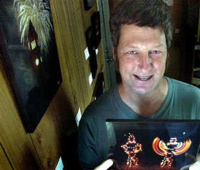 
Richard Slover poses with his work at On Sacred Grounds coffee shop at 12212 E. Palouse Highway. Slover's photography will be on display through Sept. 3.
 (Joe Barrentine / The Spokesman-Review)