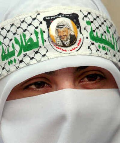 
A Palestinian woman wears a headband reading 