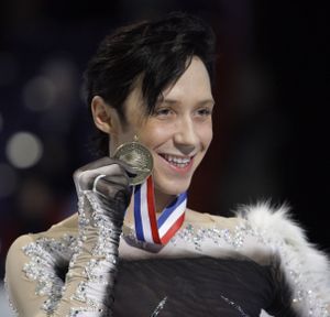 FILE - In this Jan. 17, 2010, file photo, Johnny Weir shows off his medal for third place during the men's free skate at the U.S. Figure Skating Championships in Spokane, Wash. Friends of Animals has posted an open letter to Johnny Weir criticizing him for having fox fur on one of his costumes and asking him to stop wearing fur. (Elaine Thompson / Associated Press)