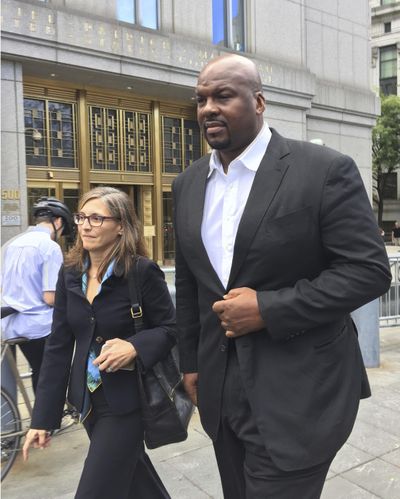 In this Oct. 10, 2017 photo, Chuck Person leaves Manhattan federal court in New York. The former Auburn assistant basketball coach is scheduled to plead guilty on Tuesday, March 19, 2019, to a conspiracy charge in a scandal that involved bribes paid to families of NBA-bound young athletes to steer them to top schools and favored money managers and agents. (Larry Neumeister / Associated Press)