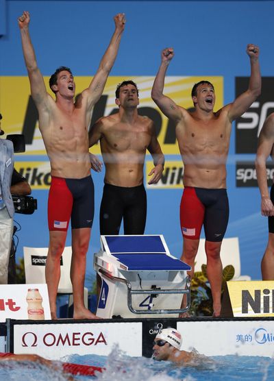 The United States 4x200 freestyle relay team celebrates its gold medal performance. (Associated Press)