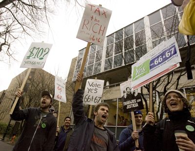 Supporters of Measures 66 and 67 rally in Portland on Friday. The  measures raise taxes on high-income earners and corporations.  (Associated Press / Associated Press)