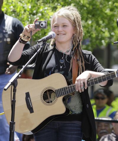 “American Idol” finalist Crystal Bowersox of Elliston, Ohio, takes a video of the crowd gathered to see her perform a short a concert in downtown Toledo, Ohio.  (Associated Press)