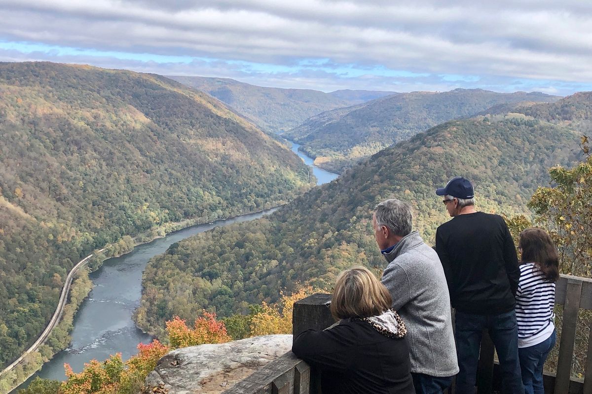 Visitors look down on the New River Gorge from a national park overlook Wednesday, Oct. 27, 2021, in Grandview, W.Va. Under legislation passed by Congress in 2020, some of America