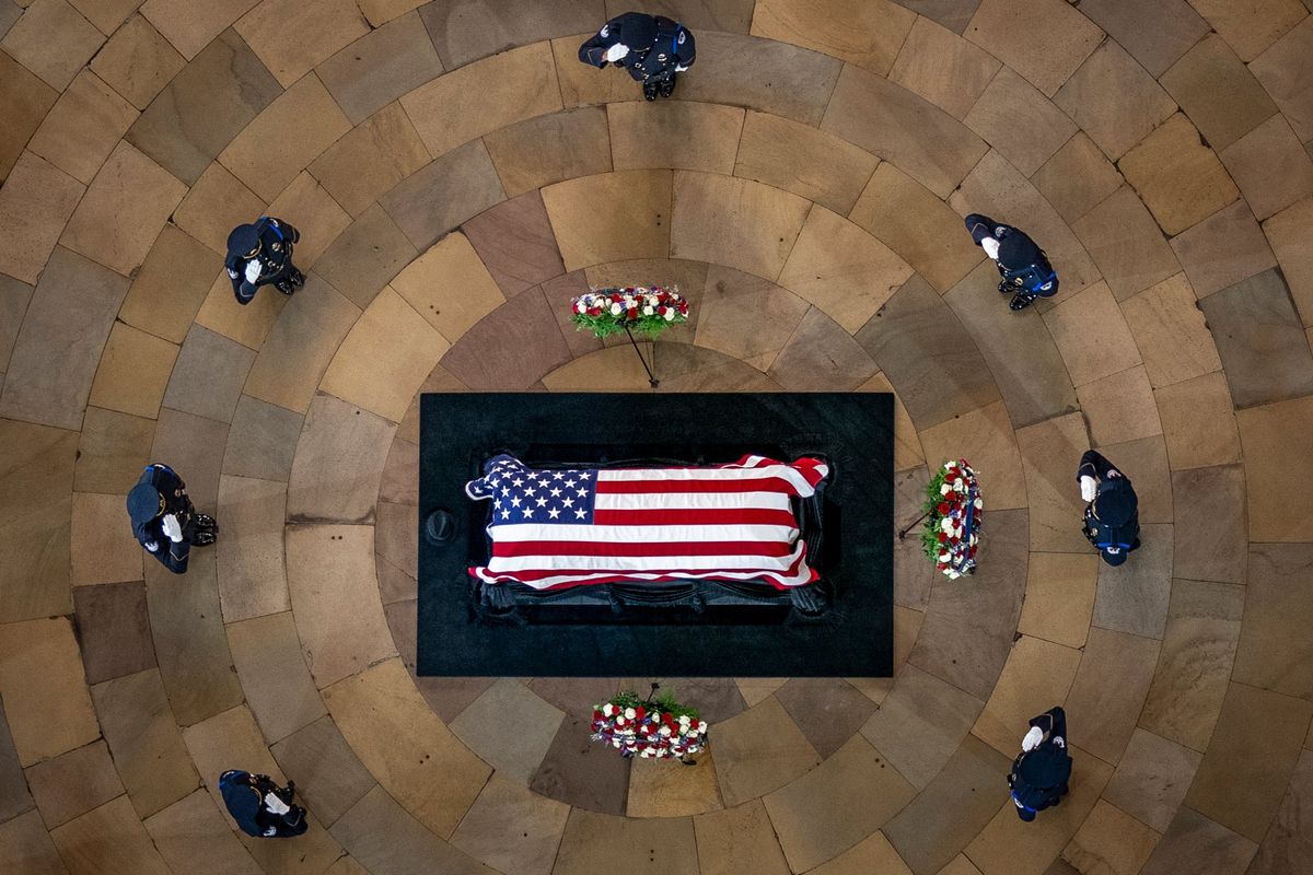 Officers salute the casket of former Sen. Harry Reid, D-Nev., as he lies in state in the Rotunda of the U.S. Capitol, Wednesday, Jan. 12, 2022, in Washington. Also pictured is Reid