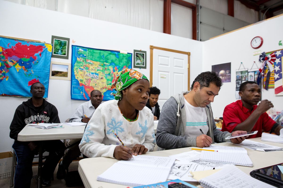 Newly resettled students take notes during an English-language class at the College of Southern Idaho Refugee Center in Twin Falls. (Kim Raff / Kim Raff Washington Post)