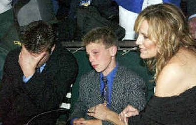 
Sherry Servis, right, wife of Smarty Jones trainer John Servis, comforts her son Tyler, center, and Blane, after Smarty Jones finished second in the Belmont.
 (Associated Press / The Spokesman-Review)