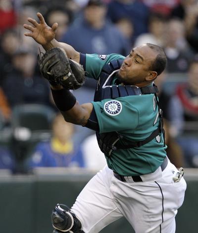 Mariners catcher Miguel Olivo chases down a foul pop-up for an out in the second inning on Friday. (Associated Press)