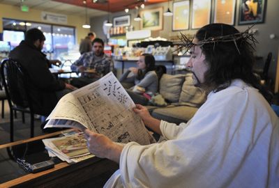 Shawn Johnston, of Kansas City, Kan., browses a newspaper at Homer’s Coffee House in Overland Park, Kan., on Tuesday.  (Associated Press / The Spokesman-Review)