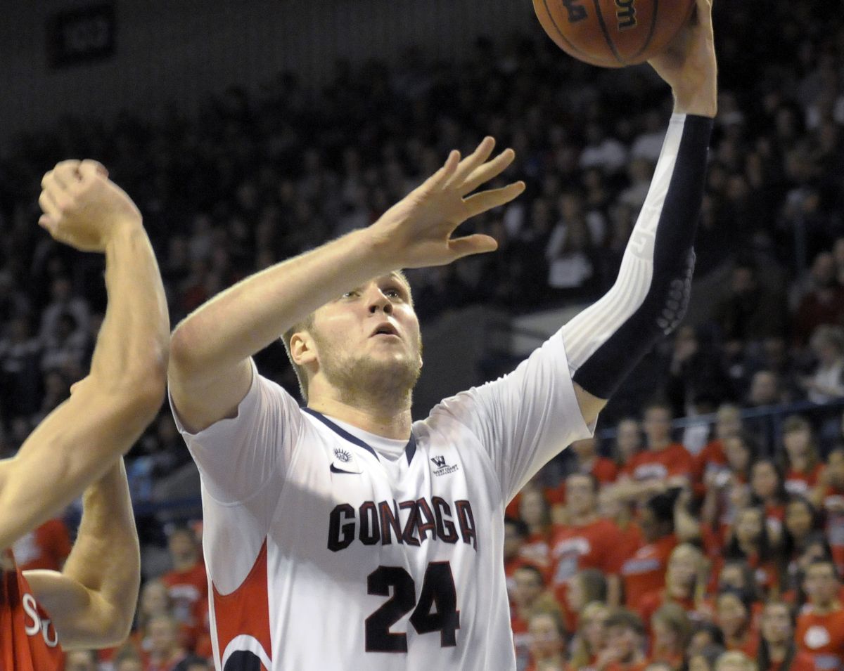 Przemek Karnowski drives to basket en route to 22 points. (Associated Press)