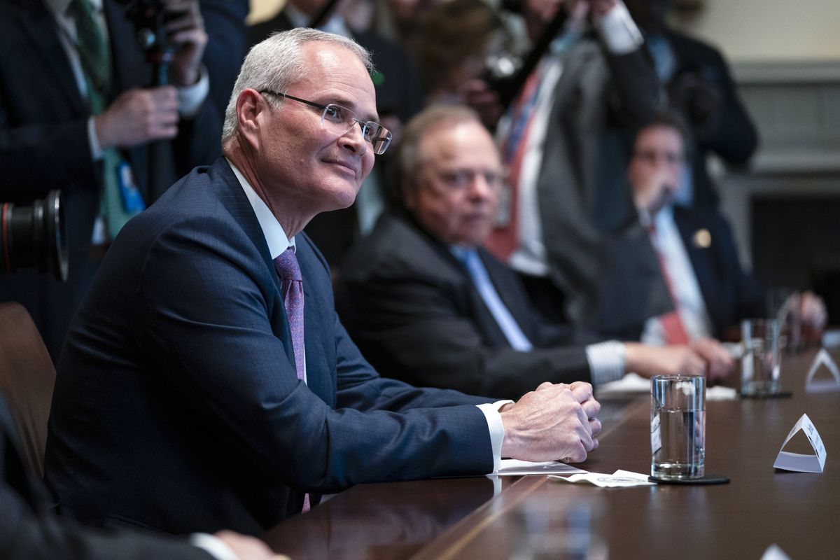 FILE - In this April 3, 2020, file photo Exxon Mobil CEO Darren Woods listens as President Donald Trump speaks during a meeting with energy sector business leaders in the Cabinet Room of the White House in Washington. Congressional Democrats are calling top executives at ExxonMobil and other oil giants to testify at a House hearing as lawmakers investigate what they say is a long-running, industry-wide campaign to spread disinformation about the role of fossil fuels in causing global warming. (Evan Vucci)