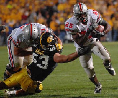 
Ohio State's Antonio Pittman (25) gets a block from teammate Steve Rehring on Saturday. 
 (Associated Press / The Spokesman-Review)