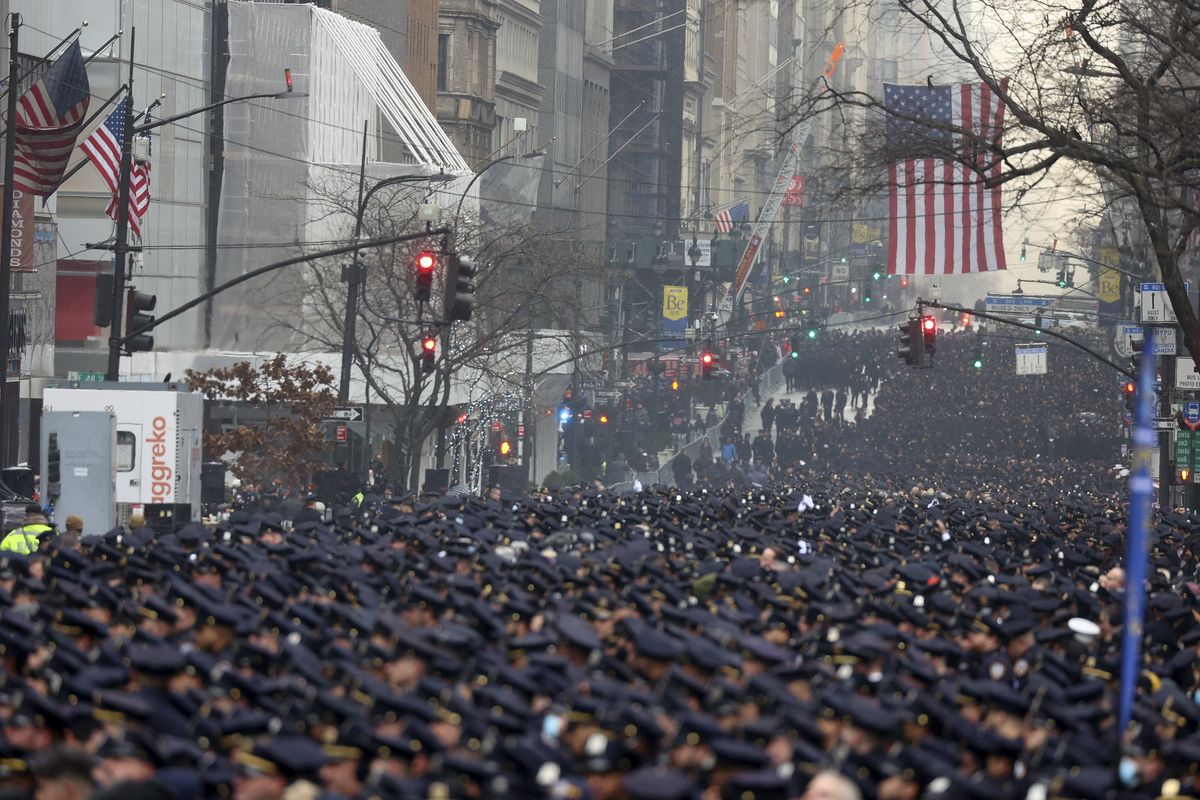New York Police officers gather along Fifth Avenue for the funeral of Officer Jason Rivera, Friday, Jan. 28, 2022, outside St. Patrick