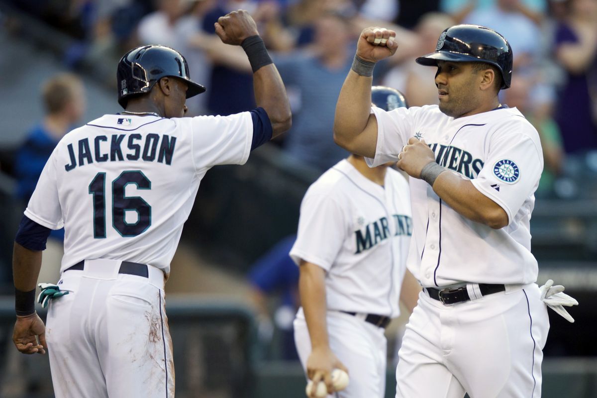 Seattle’s Kendrys Morales, right, and Austin Jackson bump fists after Morales’ first-inning home run Wednesday. (Associated Press)
