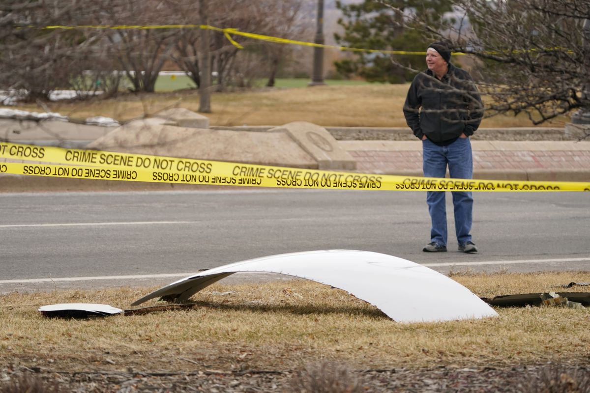 A piece of debris from a commercial airplane is surrounded by police tape on a strip along Midway Boulevard in Broomfield, Colo., after the plane shed parts while making an emergency landing at nearby Denver International Airport Saturday, Feb. 20, 2021. (David Zalubowski)