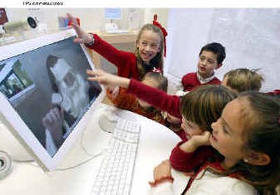 
Elementary school students use a 20-inch iMac equipped with an iSight digital video camera last year.
 (Feature Photo Service / The Spokesman-Review)