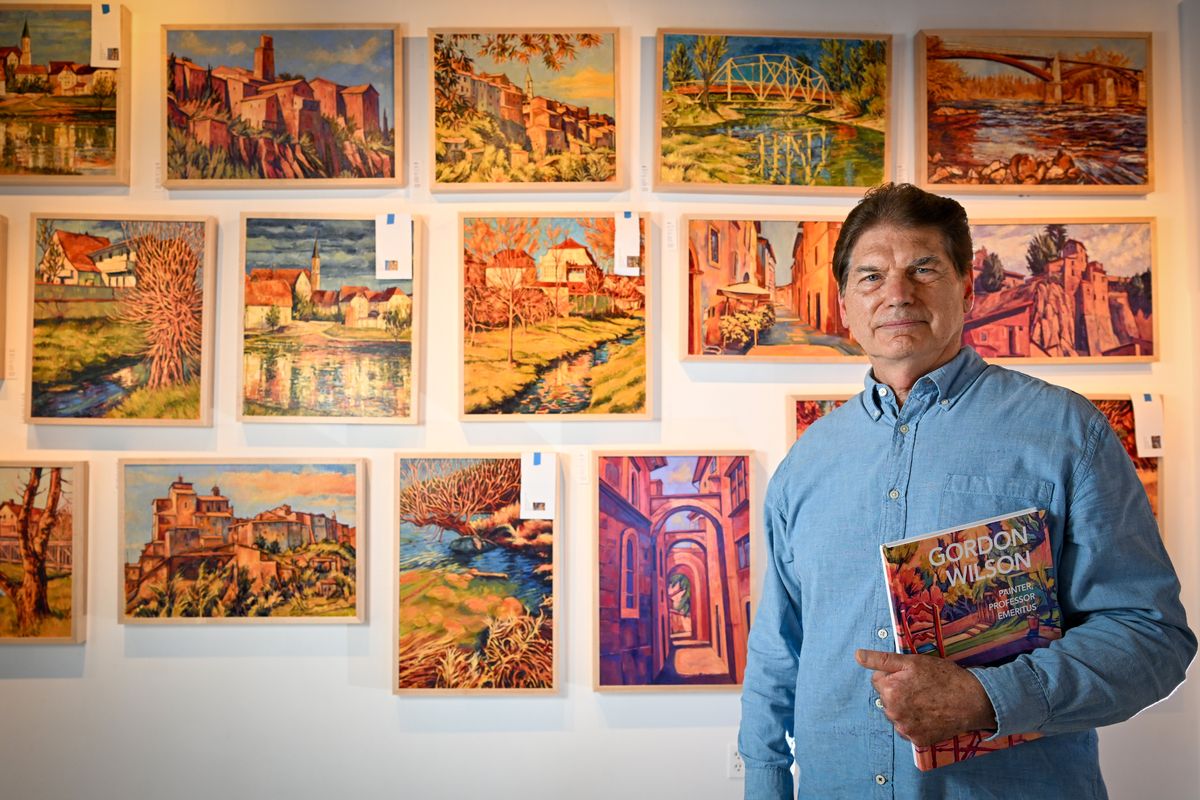 Painter Gordon Wilson is the title subject of a new book and stands in front of his art work at the Marmot Art Space. The book is by Marshall Peterson, the gallery operator of the Marmot Art Space in Kendall Yards. Photographed Aug. 25 at Marmot.  (Jesse Tinsley/THE SPOKESMAN-REVIEW)
