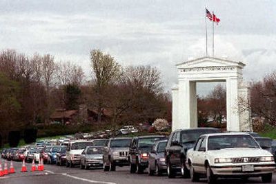 
Cars wait to cross into Canada at the Peace Arch crossing in Blaine, Wash., where two homicide suspects were stopped Jan. 24 after a car chase. 
 (File Associated Press / The Spokesman-Review)