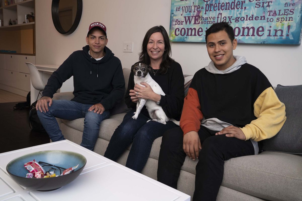 Candice Braun with Venezuelan refugees Brandon, left, and Pedro in her apartment on Oct. 7, 2022, in New York. Braun and her husband helped the pair with housing in New York.    (Barry Williams/New York Daily News/TNS)