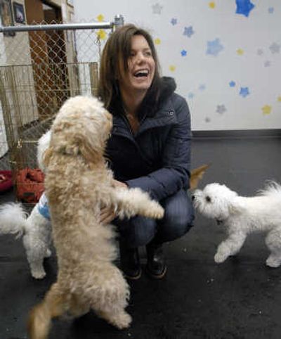 
Sonya Liu says goodbye to her dog Pinot at Alpha Dogs, a doggie day-care center. Pinot spends two to three day a week at the center.
 (Colin Mulvany / The Spokesman-Review)